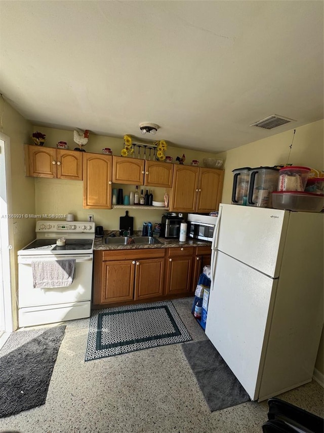 kitchen with white appliances and sink