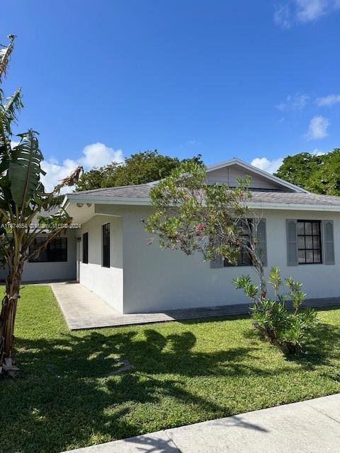 view of property exterior with a yard