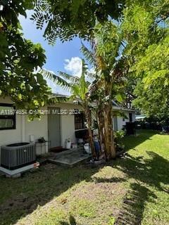 exterior space featuring a yard and cooling unit