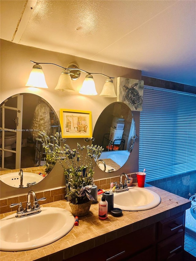 bathroom with vanity and a textured ceiling