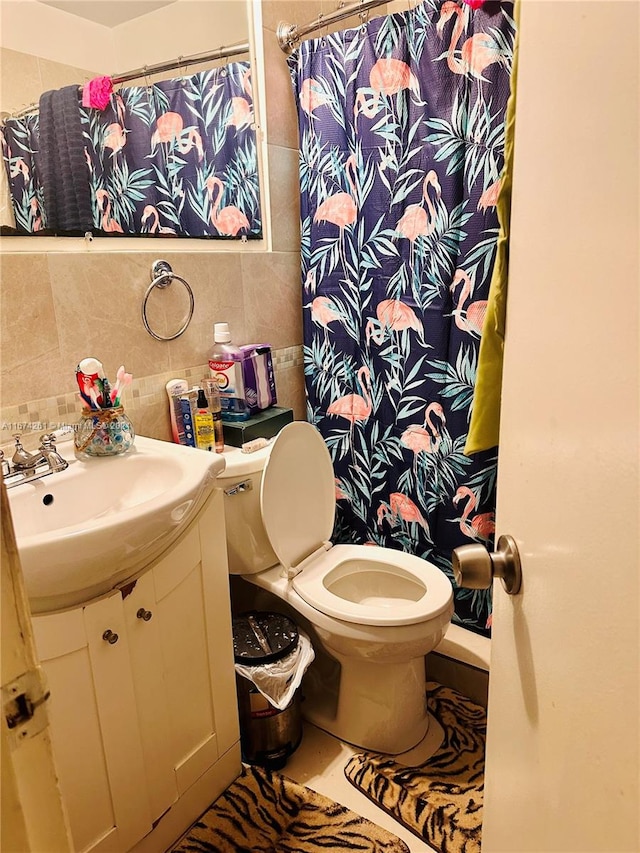 bathroom with a shower with shower curtain, vanity, tile walls, toilet, and decorative backsplash