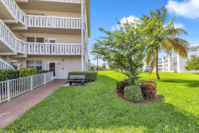 view of yard with a balcony