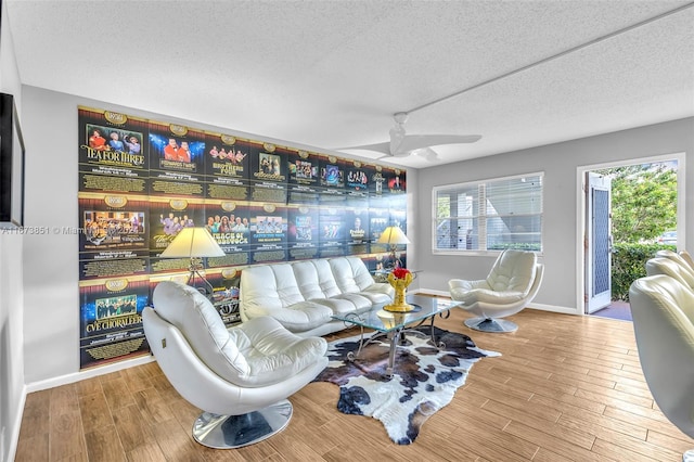 living room with wood-type flooring, a textured ceiling, and a healthy amount of sunlight