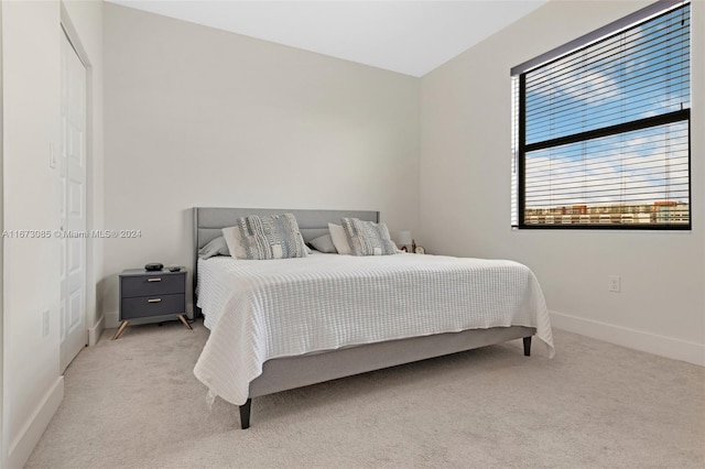 bedroom featuring light colored carpet