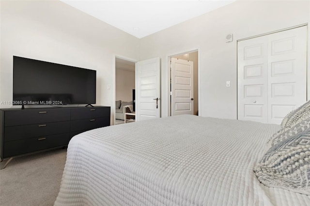 bedroom with light carpet and a closet