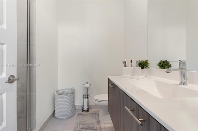 bathroom with tile patterned flooring, vanity, and toilet