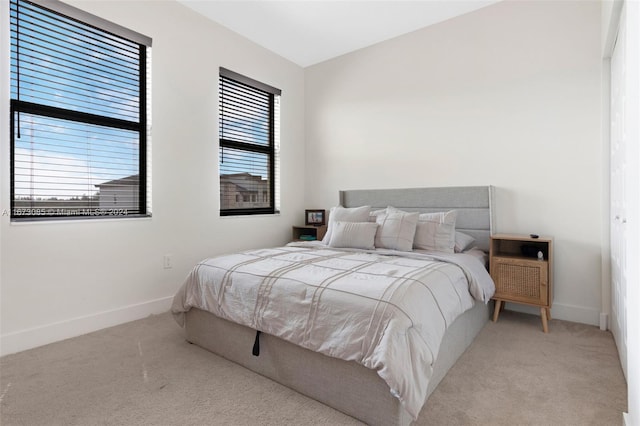 bedroom featuring light carpet