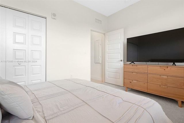 carpeted bedroom with a closet