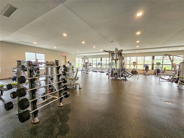 gym with a wealth of natural light and a textured ceiling