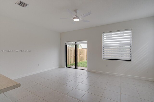 spare room with light tile patterned flooring and ceiling fan