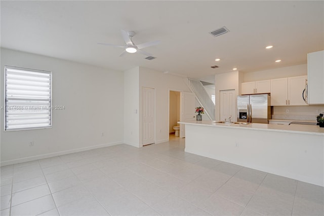 kitchen featuring light tile patterned flooring, sink, stainless steel appliances, and white cabinets