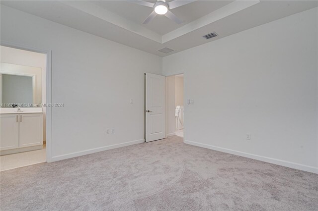 spare room featuring ceiling fan and light carpet