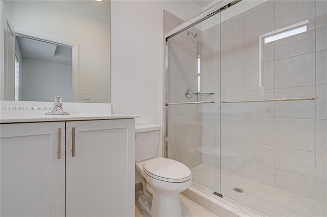 bathroom featuring vanity, walk in shower, and toilet