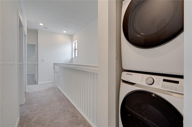 washroom featuring stacked washer and clothes dryer and light colored carpet