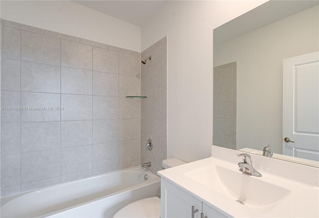 full bathroom featuring vanity, toilet, and tiled shower / bath