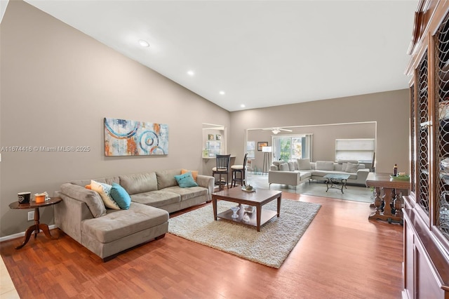 living room featuring vaulted ceiling and hardwood / wood-style flooring