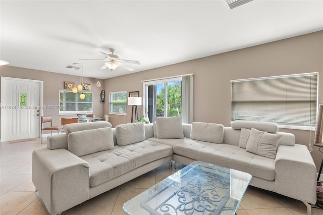 tiled living room with ceiling fan