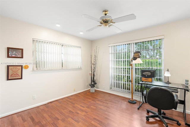 home office with hardwood / wood-style flooring and ceiling fan