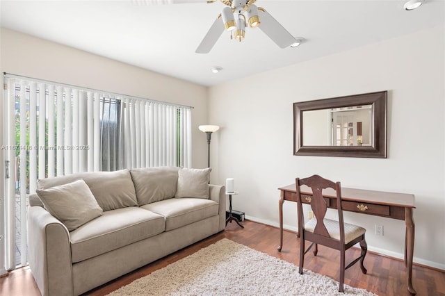 living room with wood-type flooring and ceiling fan