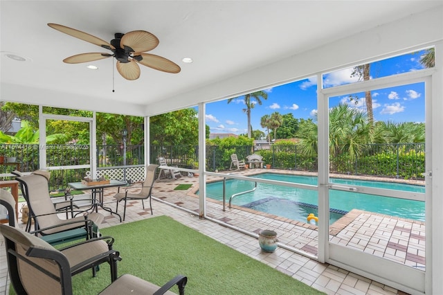 view of swimming pool with ceiling fan and a patio area