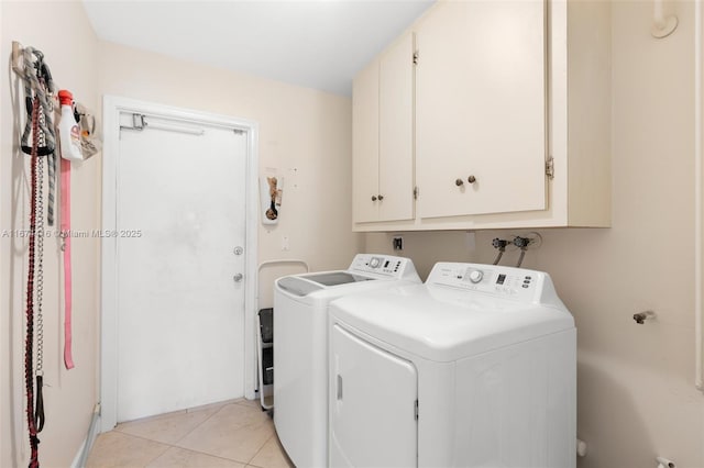 washroom featuring cabinets, separate washer and dryer, and light tile patterned floors