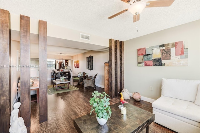 living room featuring hardwood / wood-style flooring, a textured ceiling, and ceiling fan