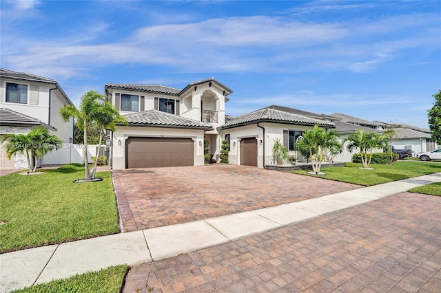 mediterranean / spanish home with a front yard and a garage