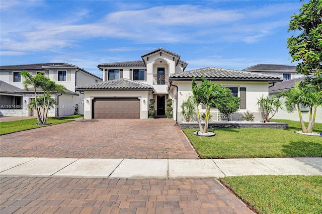 mediterranean / spanish-style home with a front yard and a garage