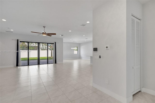 tiled spare room with ceiling fan