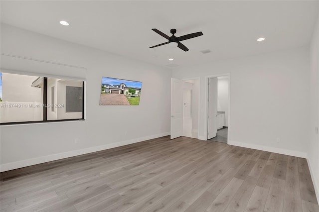 spare room with ceiling fan and light wood-type flooring