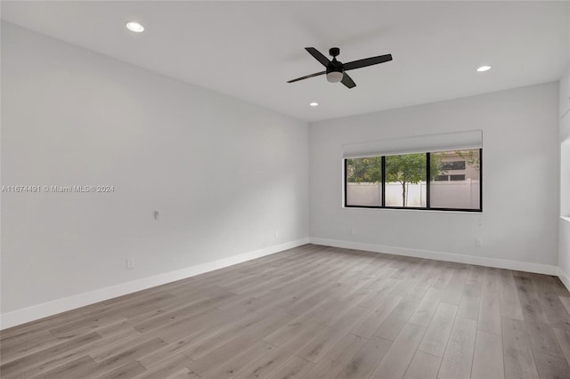 empty room featuring light wood-type flooring and ceiling fan