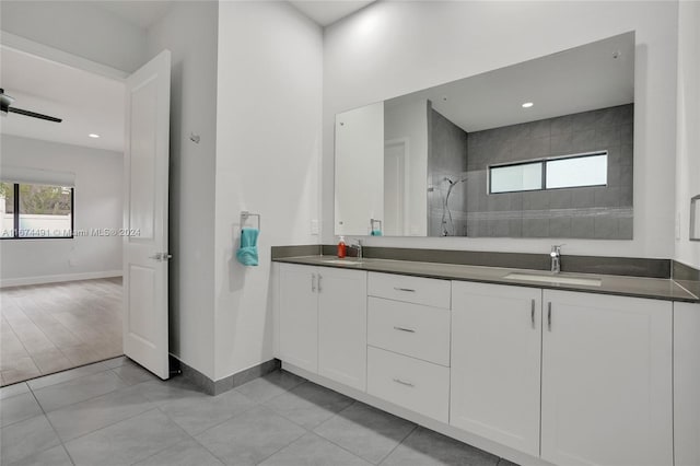 bathroom featuring vanity, a tile shower, and tile patterned floors