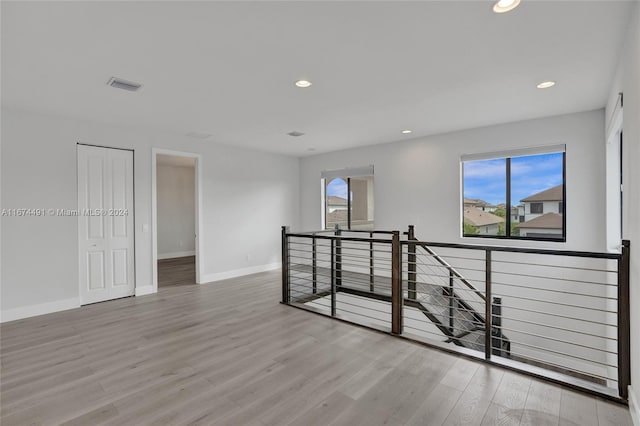 unfurnished room with light wood-type flooring