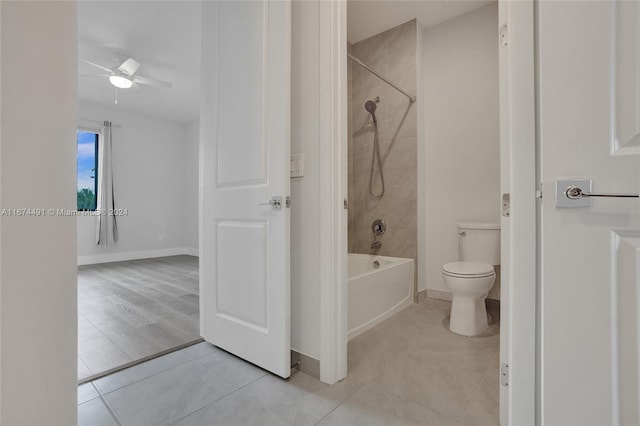 bathroom featuring tile patterned floors, tiled shower / bath combo, toilet, and ceiling fan