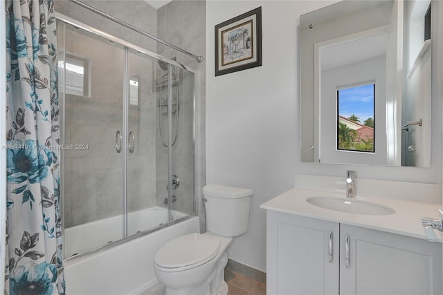 full bathroom with toilet, shower / bath combo with shower curtain, vanity, and tile patterned floors