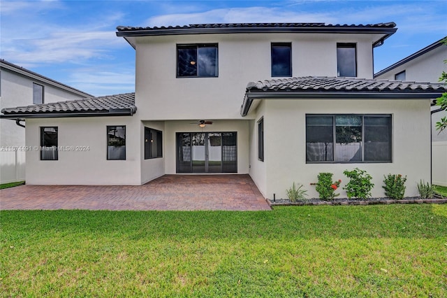 back of house featuring a patio, ceiling fan, and a lawn