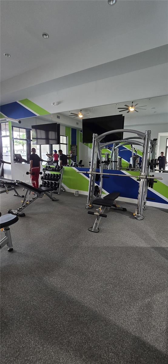 exercise room with ceiling fan