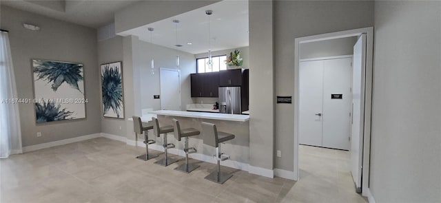 kitchen featuring white cabinetry, a breakfast bar, and stainless steel fridge with ice dispenser