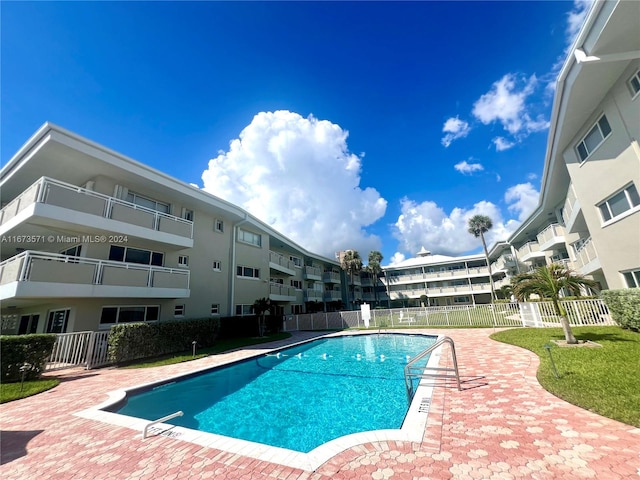 view of swimming pool featuring a yard