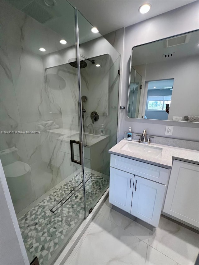 bathroom with walk in shower and vanity