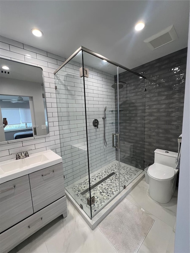 bathroom with an enclosed shower, toilet, tile walls, and vanity