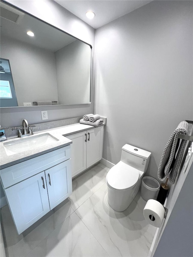 bathroom with toilet and vanity