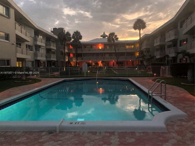 view of pool at dusk