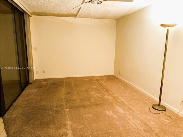 spare room with ceiling fan, carpet floors, and a textured ceiling