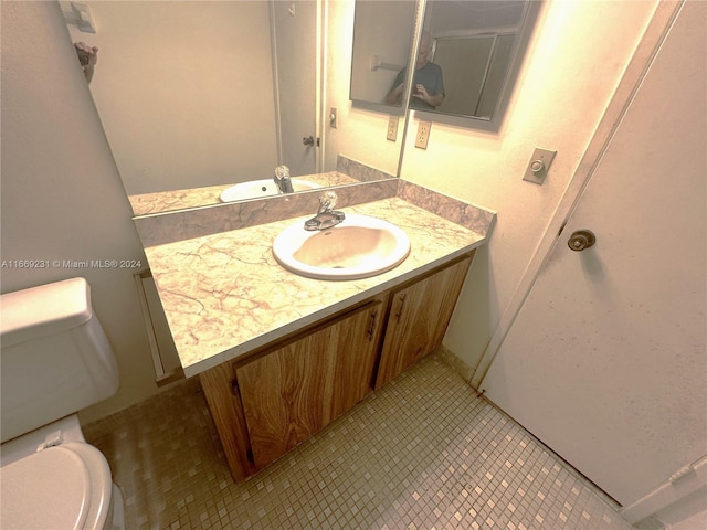 bathroom with vanity, toilet, and tile patterned floors