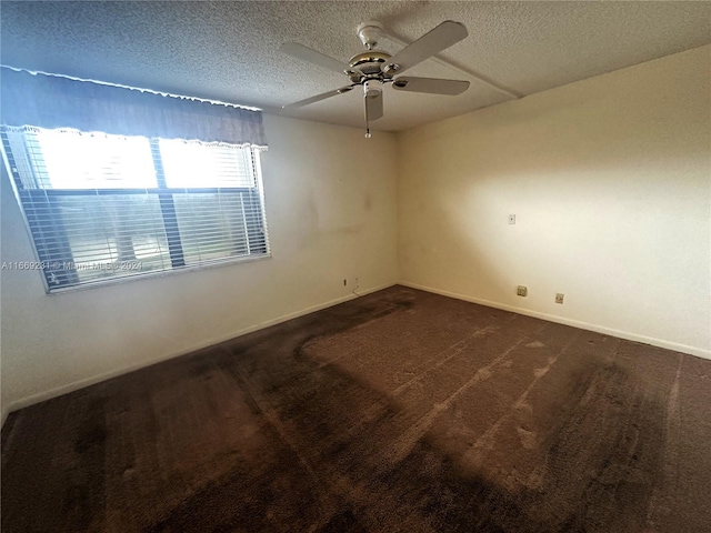 carpeted spare room with ceiling fan and a textured ceiling