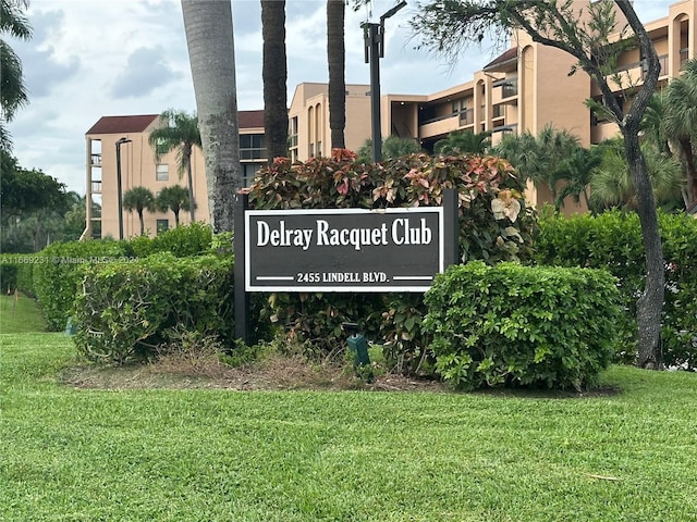 community / neighborhood sign with a lawn