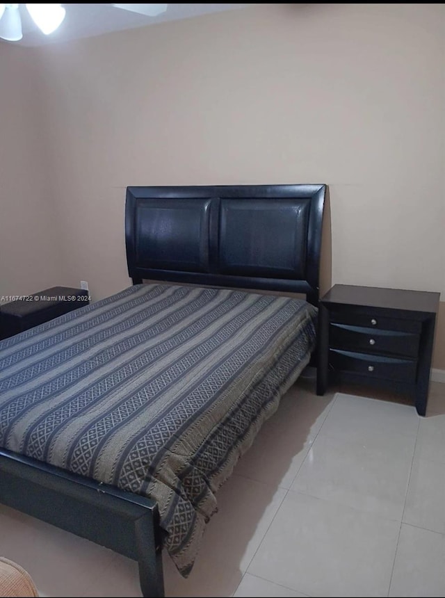 bedroom featuring light tile patterned flooring and ceiling fan