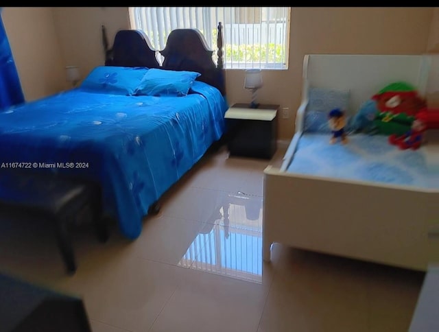 bedroom featuring light tile patterned flooring