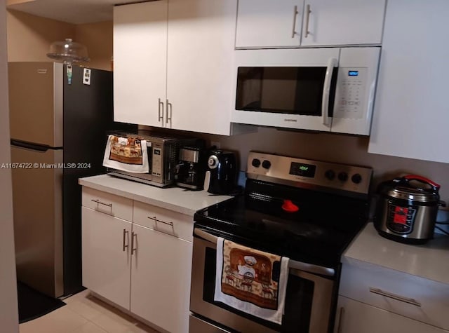 kitchen featuring appliances with stainless steel finishes and white cabinetry